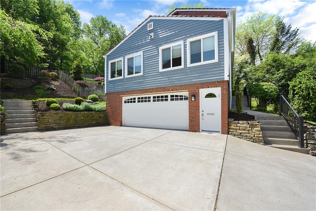719 Pinetree Road Pittsburgh, PA 15243 - Photo 30 of 35 a front view of a house with a yard and garage