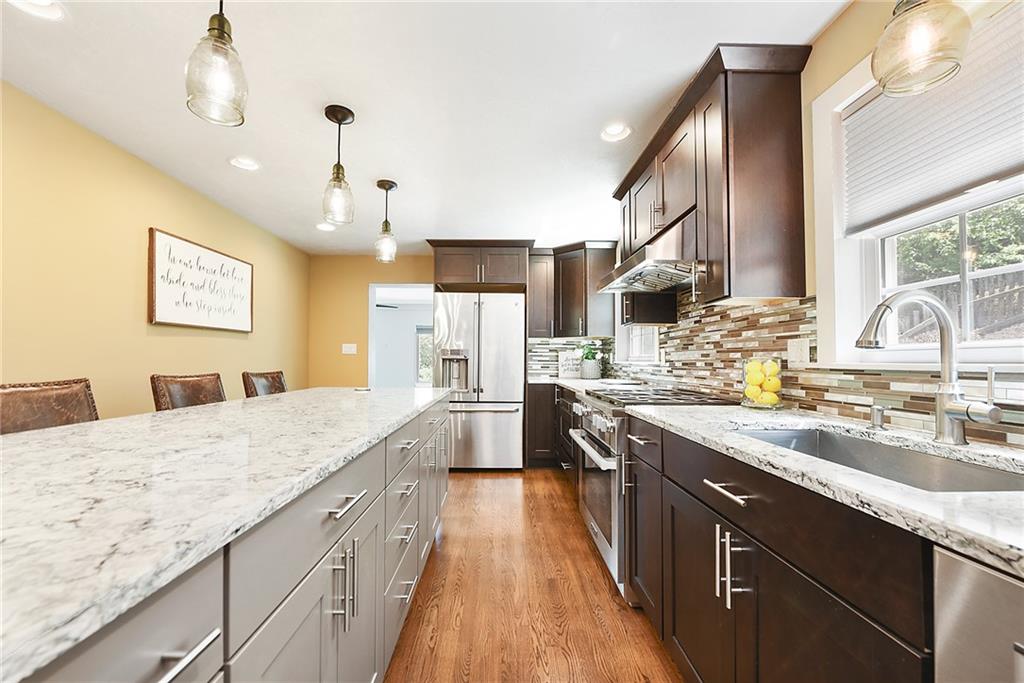 719 Pinetree Road Pittsburgh, PA 15243 - Photo 8 of 35 a large kitchen with a sink and cabinets