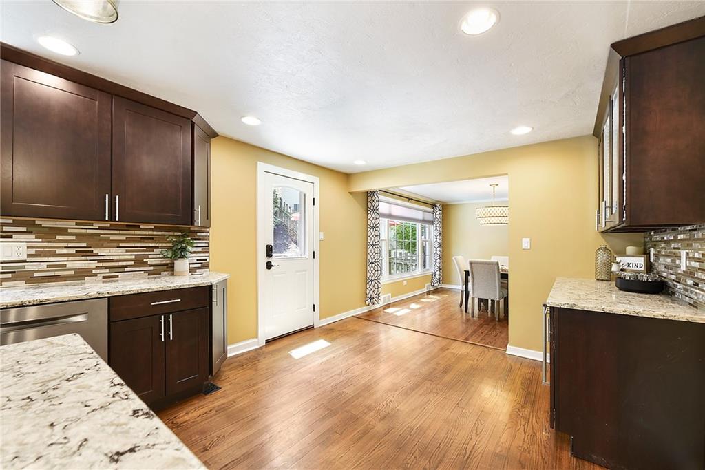 719 Pinetree Road Pittsburgh, PA 15243 - Photo 10 of 35 a large kitchen with kitchen island granite countertop a large counter top stainless steel appliances and wooden cabinets