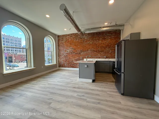 a kitchen with stainless steel appliances granite countertop a refrigerator a sink a stove and island