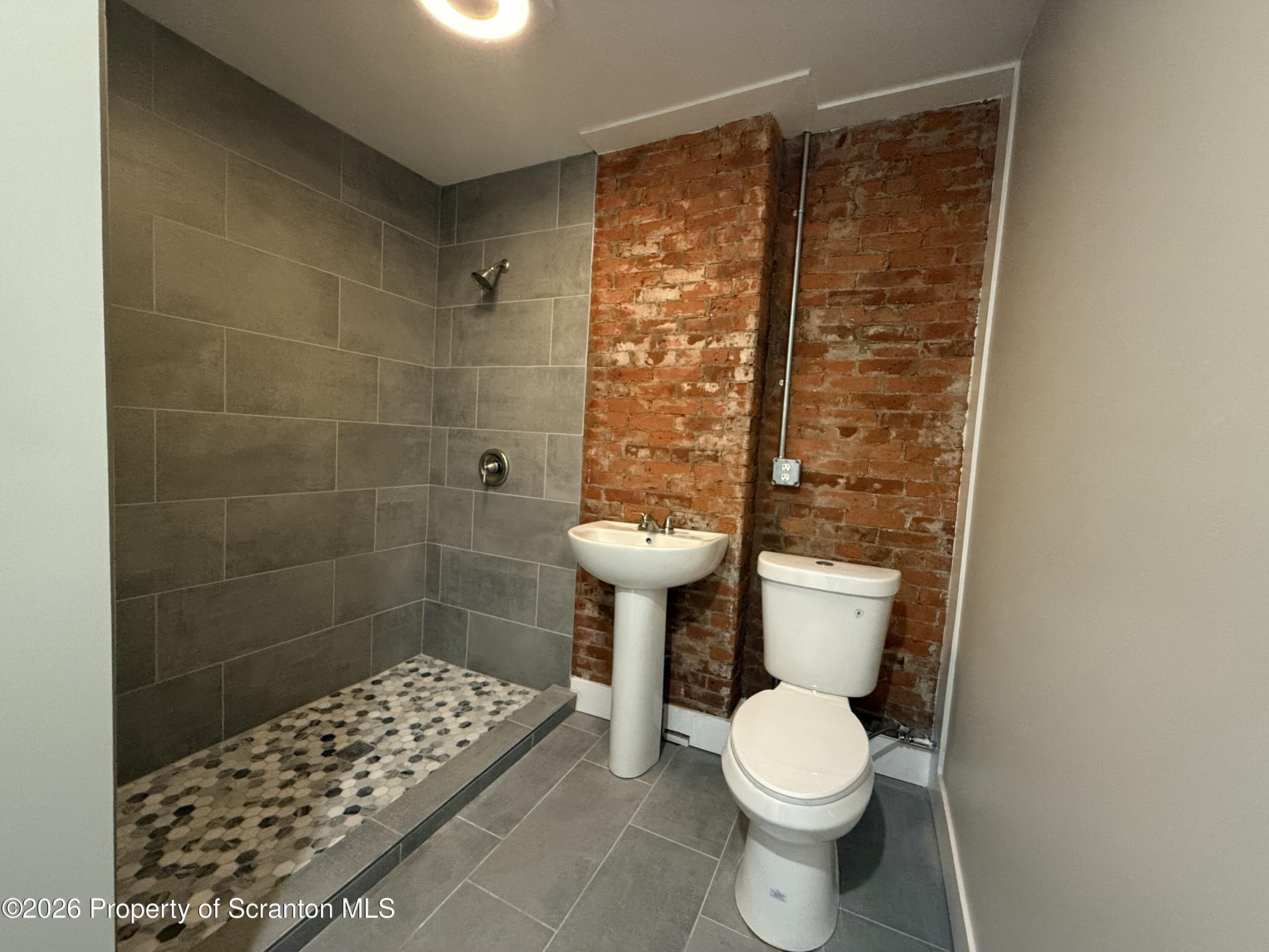 205 North Washington Avenue, Unit 9 Scranton, PA 18503 - Photo 5 of 6 a white toilet sitting next to a bathroom sink