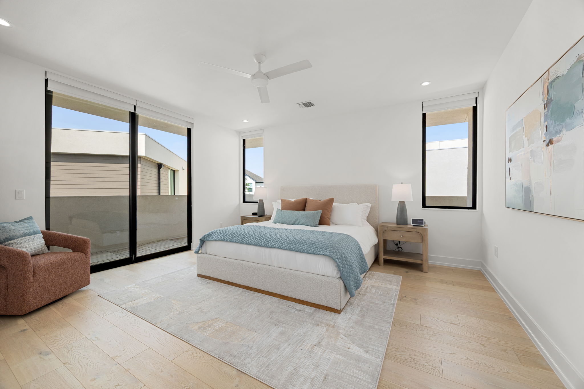 2524 Doc Reeves Street Austin, TX 78723 - Photo 15 of 36 Sliding glass doors open to a private balcony from this modern bedroom with hardwood flooring.