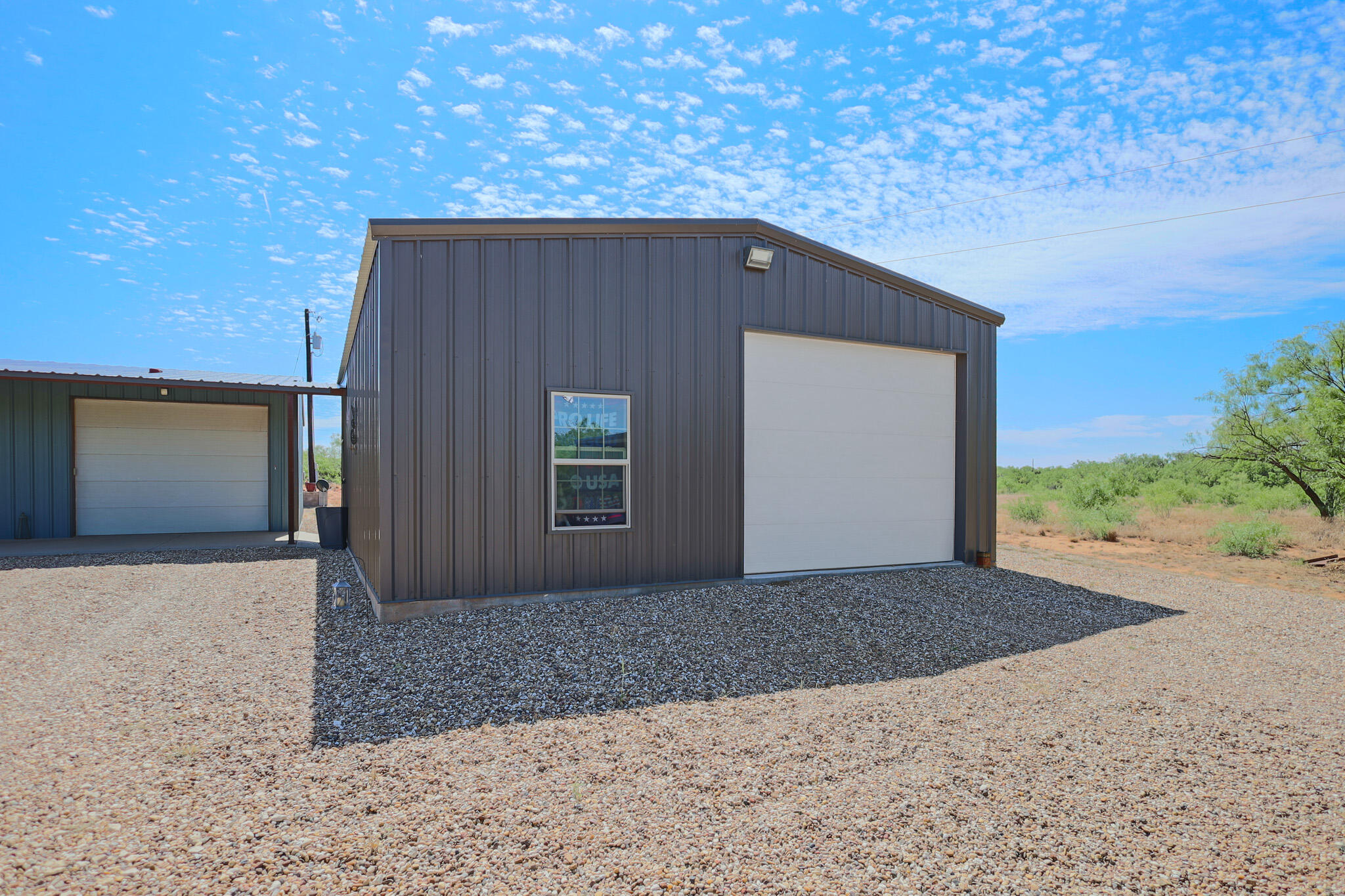 301 Fagan Road Snyder, TX 79549 - Photo 12 of 102 a backyard of a house with garage and yard