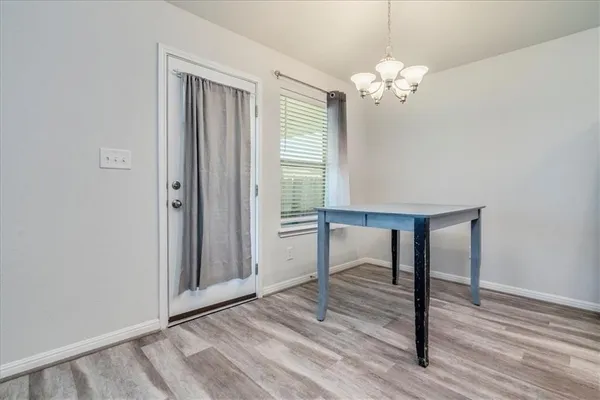 a view of a livingroom with a window and wooden floor