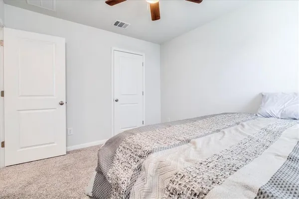 a bedroom with a bed and cabinets