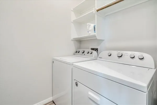 a utility room with dryer and cabinets