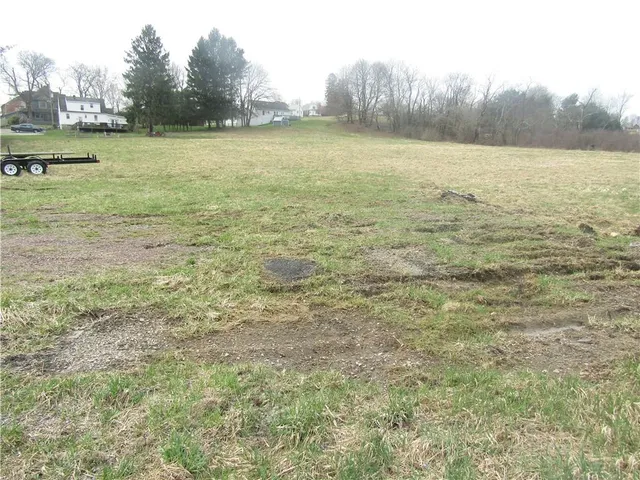 a view of a field with an ocean view