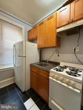 a kitchen with stainless steel appliances granite countertop a refrigerator and a stove