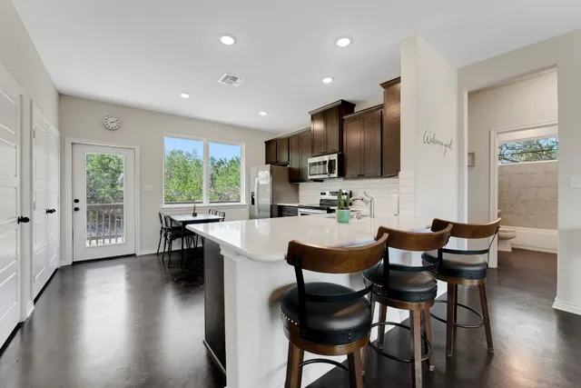a kitchen with a sink stainless steel appliances and cabinets