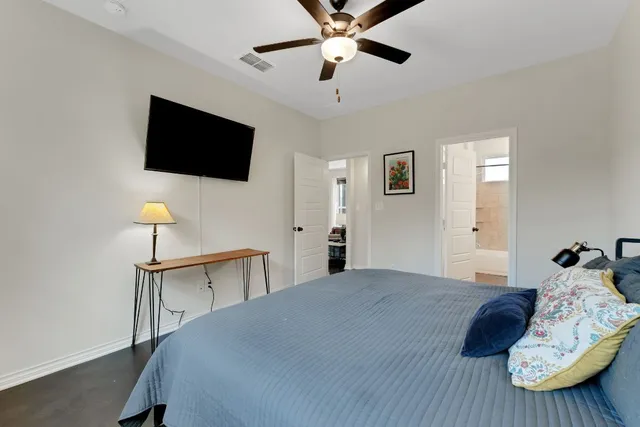 a bedroom with a bed window and a lamp on table