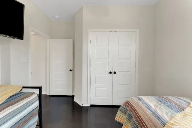 a bedroom with two beds and a window