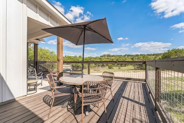a view of a balcony with lake view and wooden floor