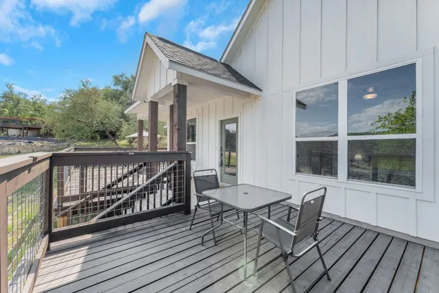 a view of balcony with wooden floor and seating space