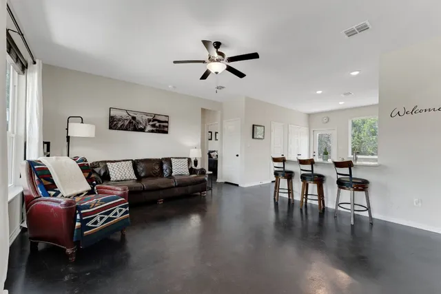 a living room with furniture and wooden floor
