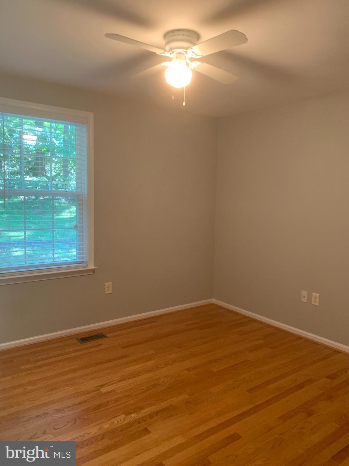 2143 Brackenville Road Hockessin, DE 19707 - Photo 19 of 26 a view of empty room with wooden floor and fan