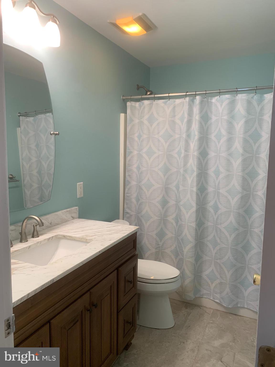 2143 Brackenville Road Hockessin, DE 19707 - Photo 20 of 26 a bathroom with a sink a toilet and a mirror