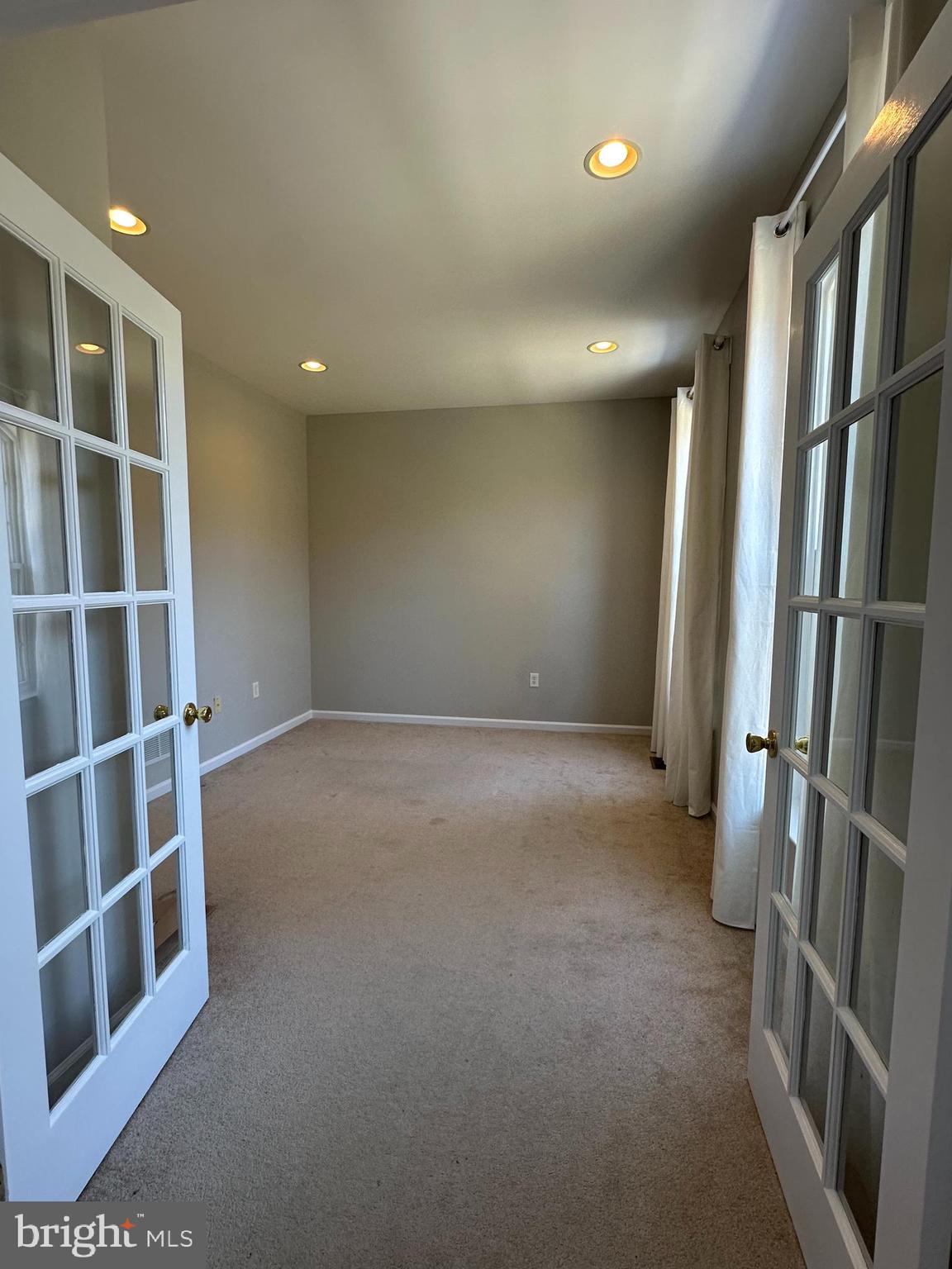 2143 Brackenville Road Hockessin, DE 19707 - Photo 3 of 26 a view of an empty room with wooden floor and a window