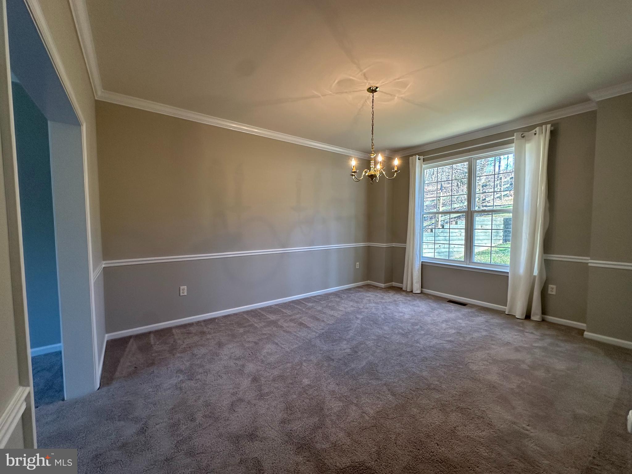 2143 Brackenville Road Hockessin, DE 19707 - Photo 5 of 26 an empty room with chandelier fan and windows