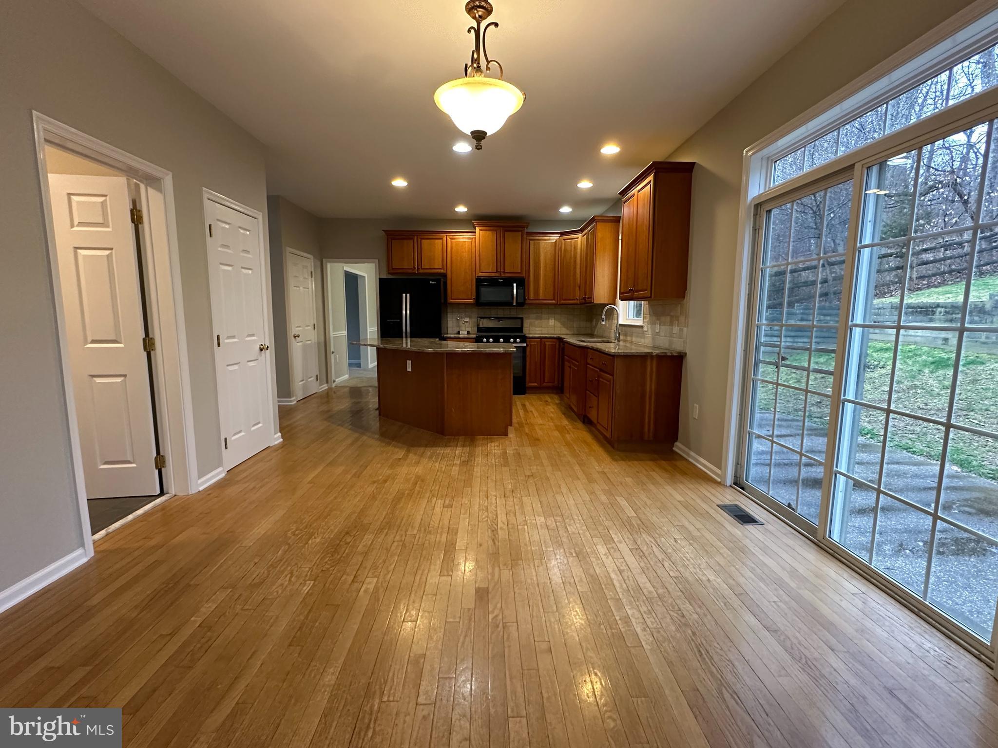 2143 Brackenville Road Hockessin, DE 19707 - Photo 6 of 26 a view of a kitchen with kitchen island wooden floor center island and stainless steel appliances