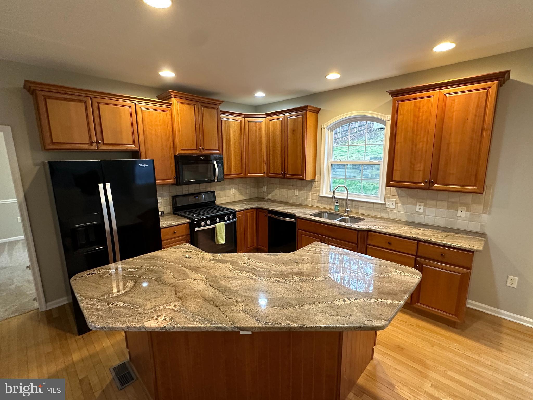 2143 Brackenville Road Hockessin, DE 19707 - Photo 8 of 26 a kitchen with granite countertop a sink a counter top space appliances and cabinets