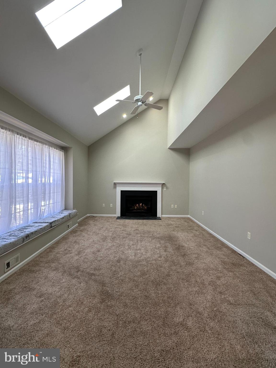 2143 Brackenville Road Hockessin, DE 19707 - Photo 10 of 26 a view of an empty room with a fireplace and a window