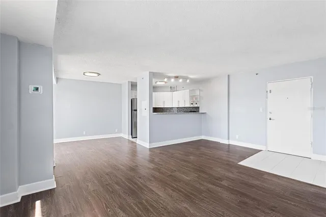 a view of a kitchen with wooden floor and a sink