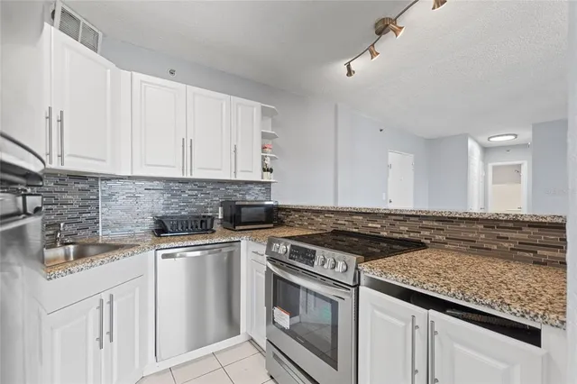 a stove top oven sitting inside of a kitchen