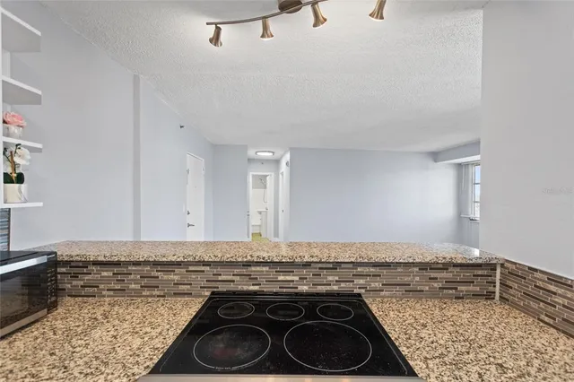 a kitchen with a stove and cabinets