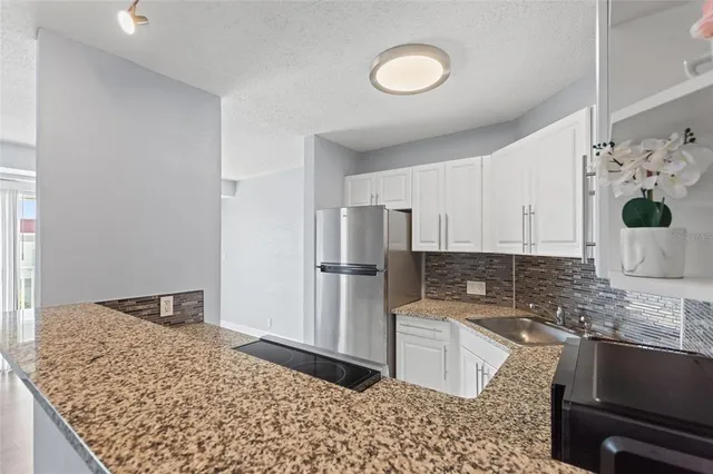 a kitchen with a refrigerator and a sink