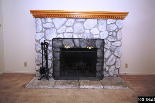 1425 Allen Street Reno, NV 89509 - Photo 5 of 13 a fireplace with a wooden floor