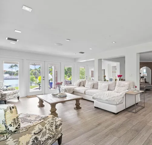 a view of a dining room with furniture a chandelier and wooden floor
