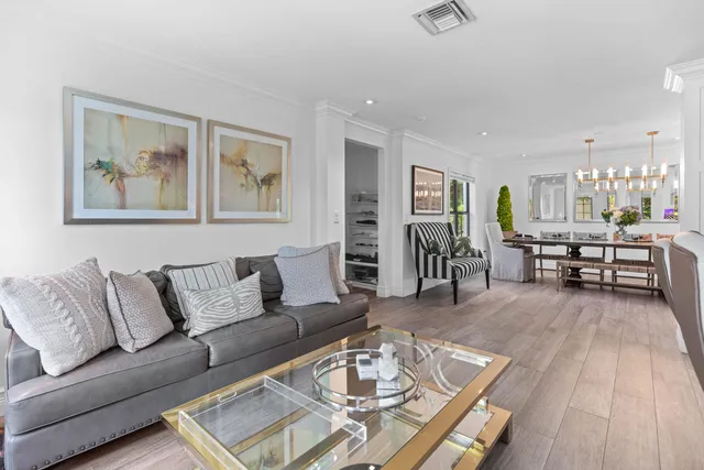 a living room with patio furniture and a garden