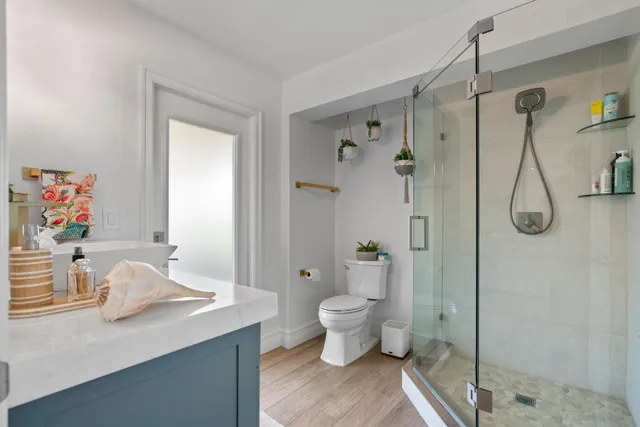 a living room with patio furniture and a garden