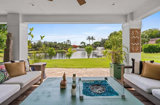 a front view of a house with a yard and potted plants