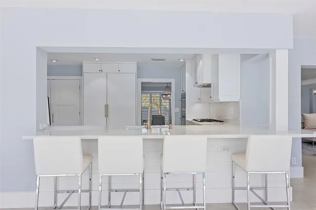 a kitchen with cabinets appliances and a window