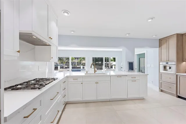 a living room with furniture a flat screen tv and a large window