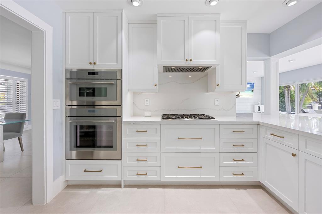 2330 Northeast 35th Street Lighthouse Point, FL 33064 - Photo 18 of 71 a kitchen with cabinets appliances and a window