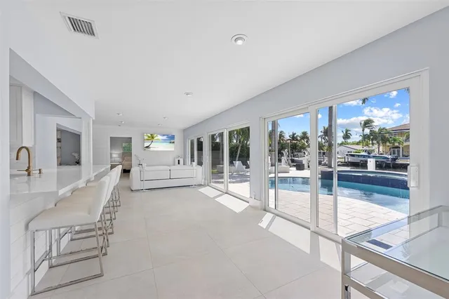 a bedroom with a bed and a large window with the outer view