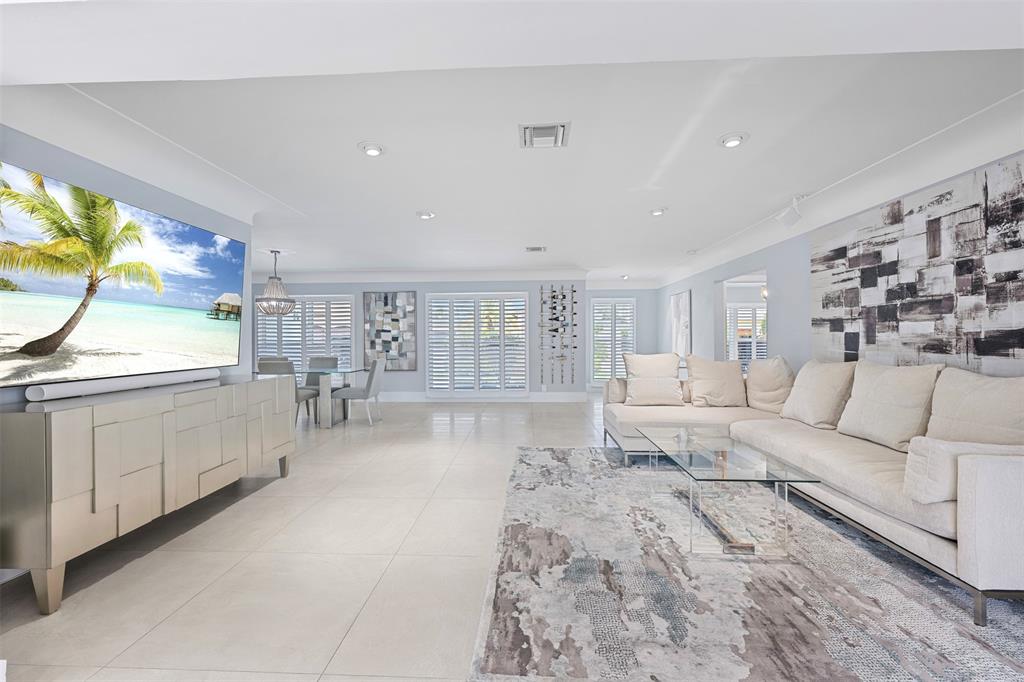 2330 Northeast 35th Street Lighthouse Point, FL 33064 - Photo 20 of 71 a living room with furniture a flat screen tv and a large window