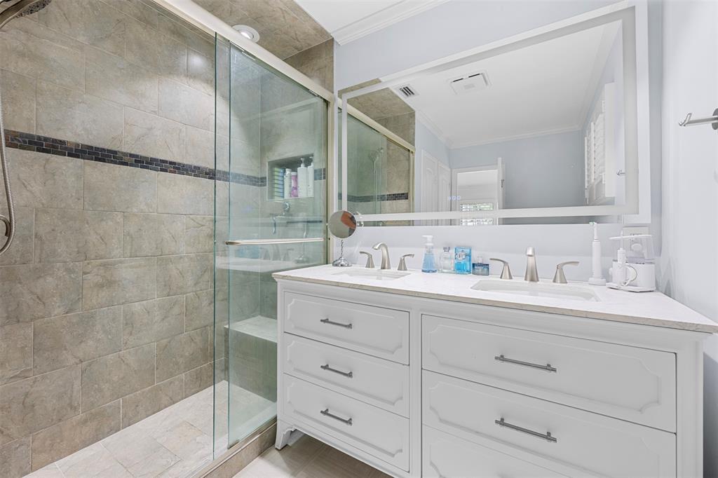 2330 Northeast 35th Street Lighthouse Point, FL 33064 - Photo 24 of 71 a bathroom with a shower sink and mirror