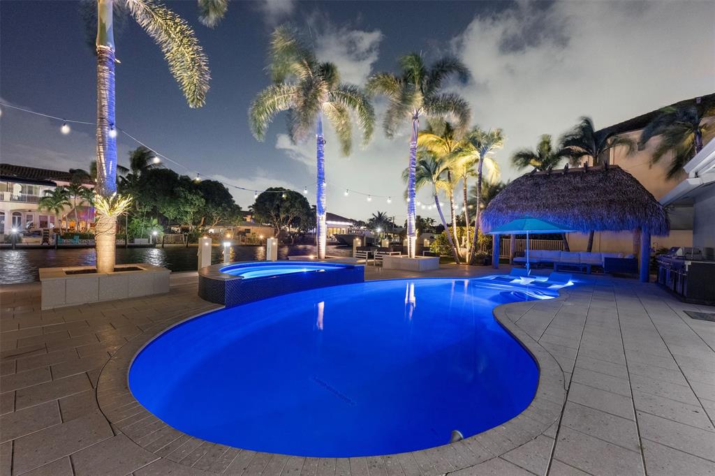 2330 Northeast 35th Street Lighthouse Point, FL 33064 - Photo 31 of 71 a view of a swimming pool with tables and chairs