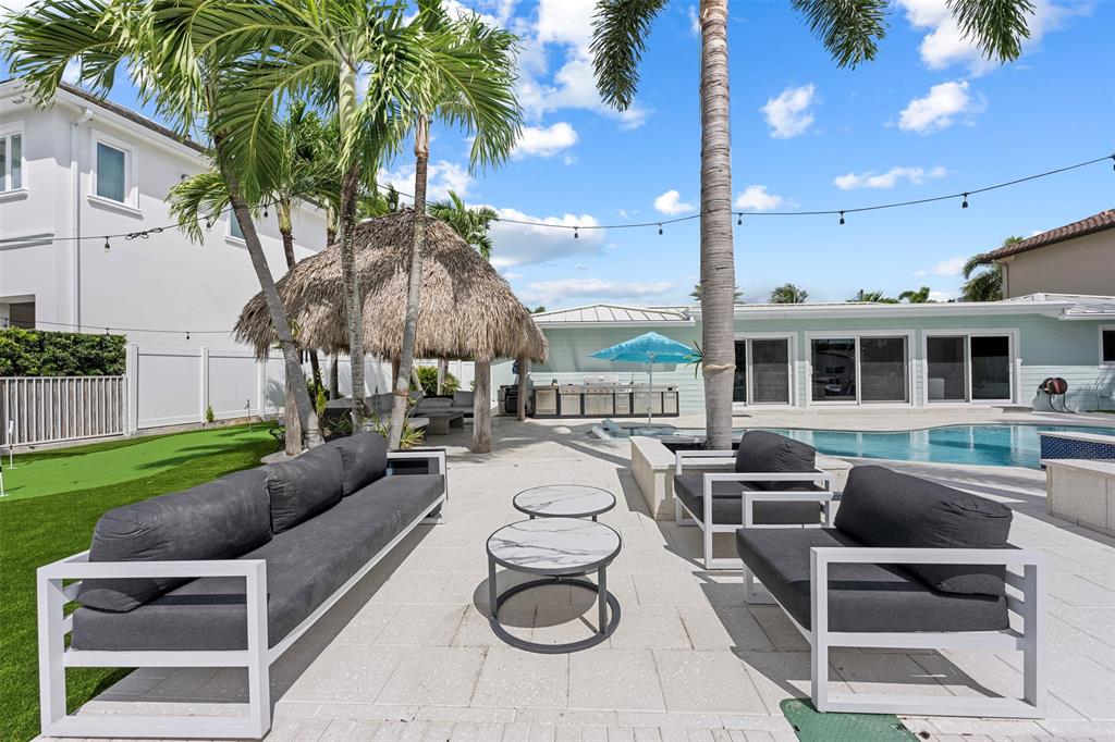 2330 Northeast 35th Street Lighthouse Point, FL 33064 - Photo 33 of 71 a swimming pool with outdoor seating and yard