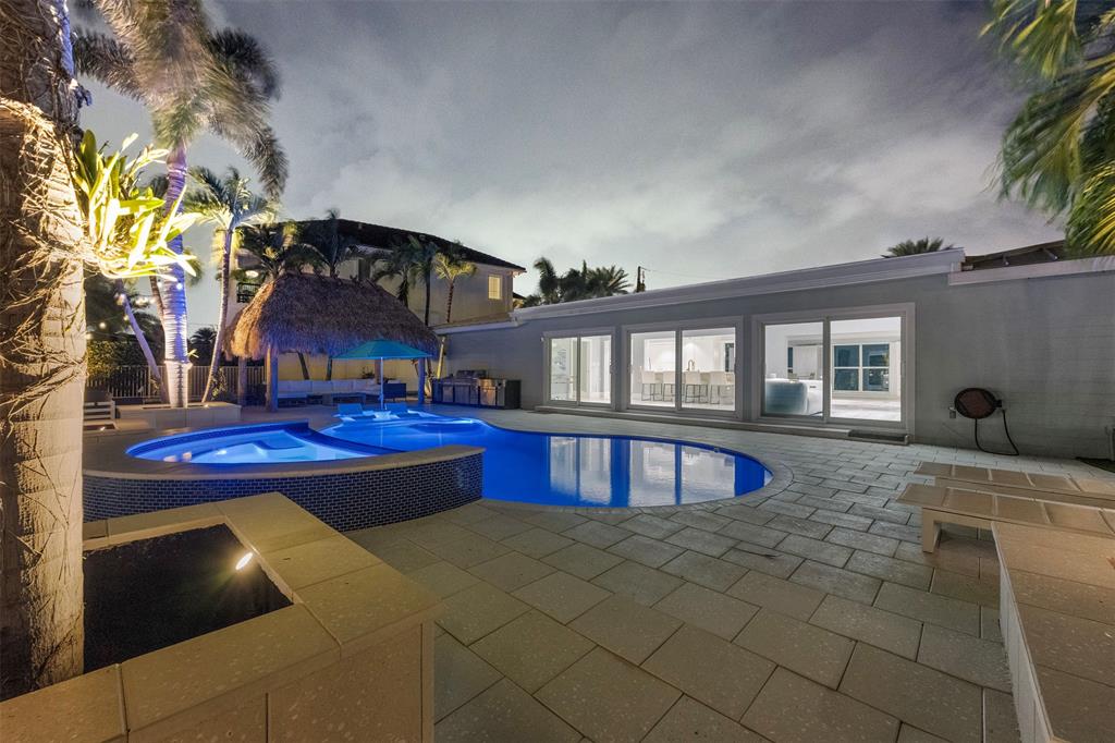 2330 Northeast 35th Street Lighthouse Point, FL 33064 - Photo 43 of 71 a view of a house with a swimming pool and sitting area