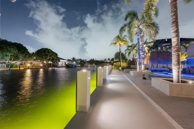 a view of a white house with a yard and sitting area