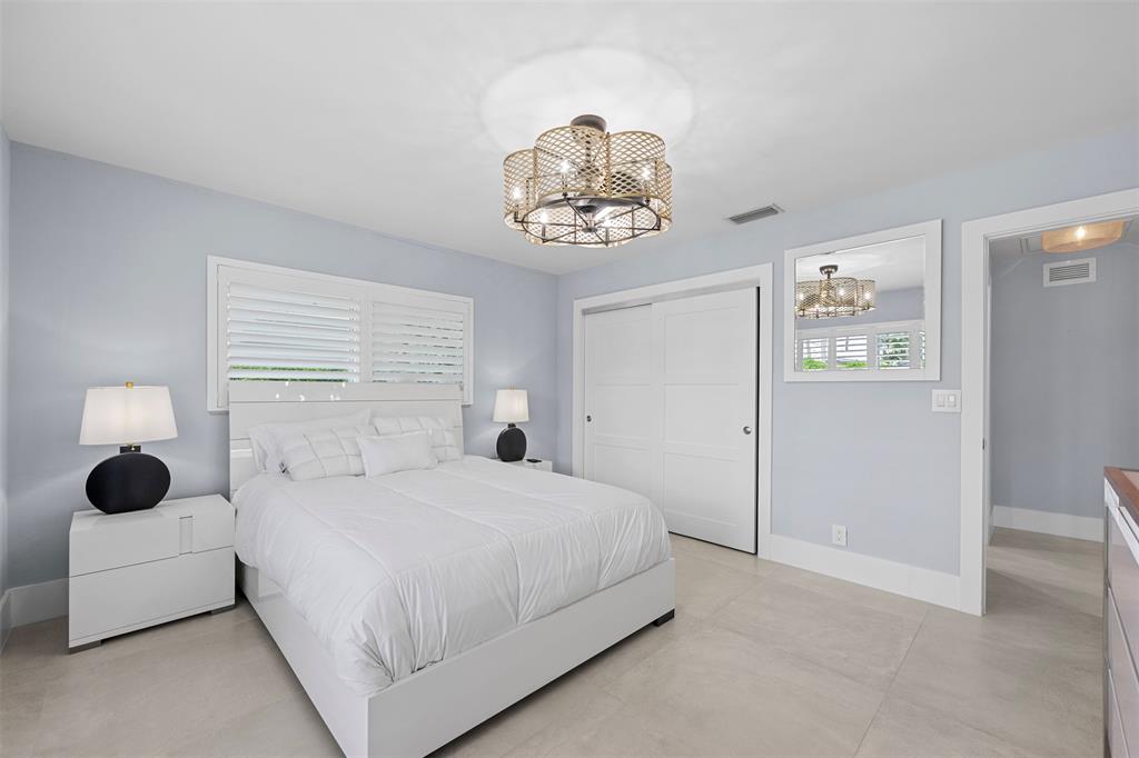 2330 Northeast 35th Street Lighthouse Point, FL 33064 - Photo 53 of 71 a bedroom with a bed and a window