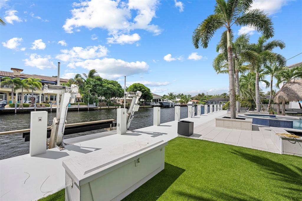 2330 Northeast 35th Street Lighthouse Point, FL 33064 - Photo 59 of 71 a view of a swimming pool with a patio and a garden