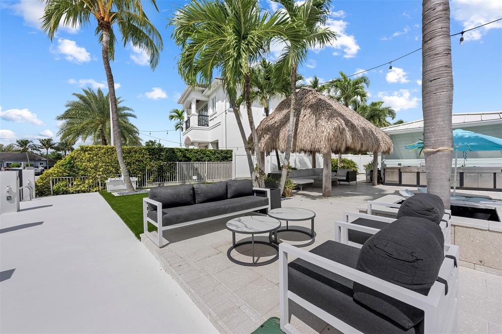 2330 Northeast 35th Street Lighthouse Point, FL 33064 - Photo 62 of 71 a view of a patio with couches and a potted plant on a table and chairs