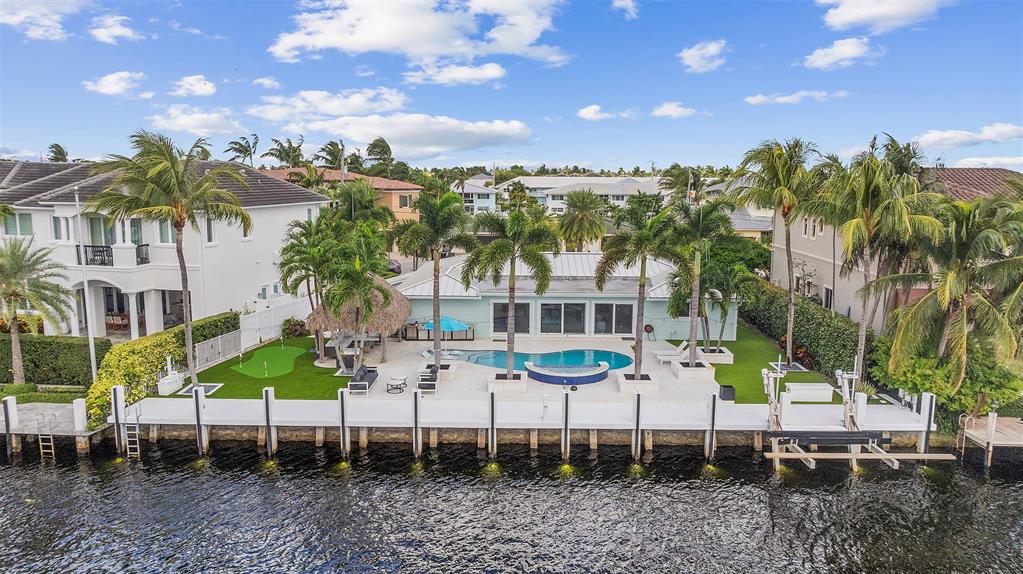 2330 Northeast 35th Street Lighthouse Point, FL 33064 - Photo 64 of 71 a view of a white house with a yard and sitting area