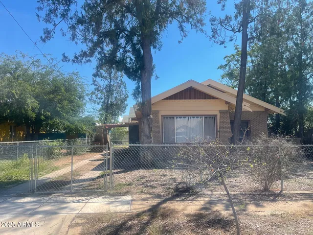a view of a house with a yard next to a road