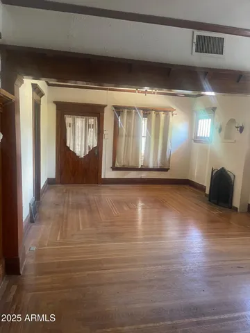 a view of room with window and wooden floor